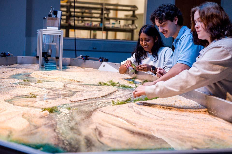 Students work with the Water and Sediment Flume in the WATER Institute 