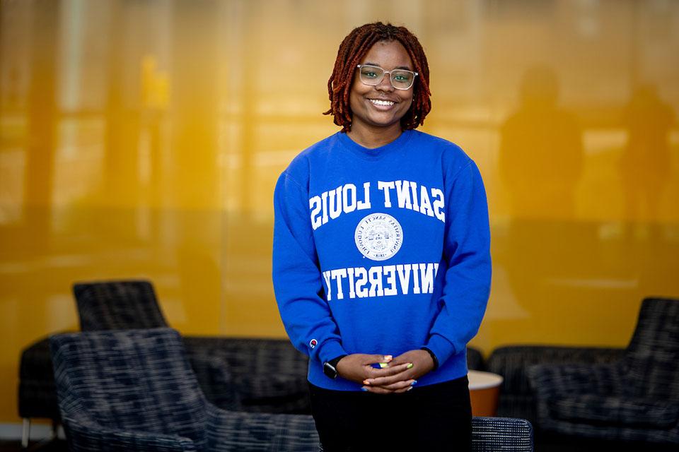 Malaisyah Vann poses for a photo wearing a blue Saint Louis University sweatshirt.